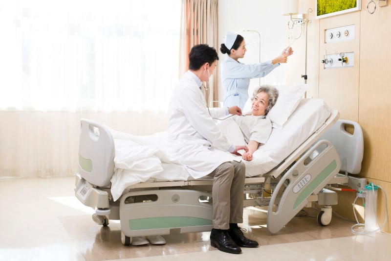 Doctor using stethoscope on patient in hospital