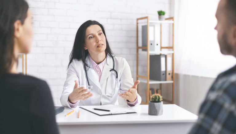 Physician explaining symptoms to patients during consultation