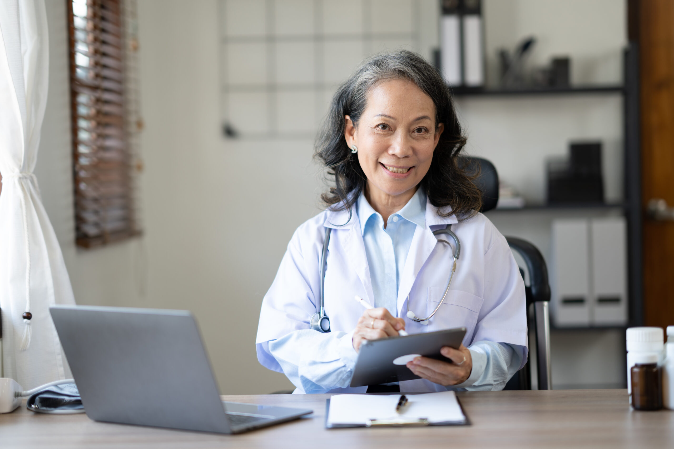 Female doctor using EHR Software in Healthcare clinic